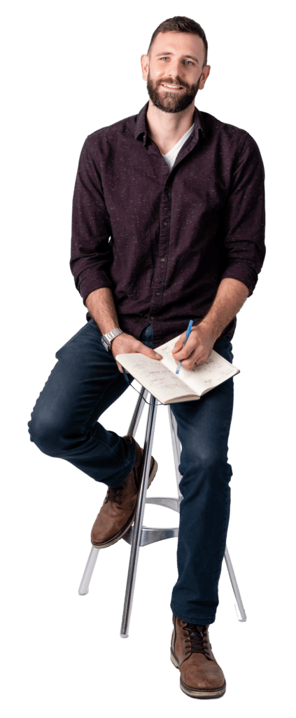 David Fenoulhet sitting on stool with notebook