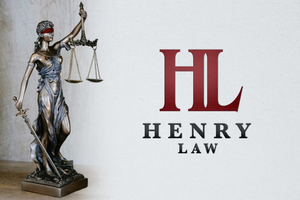 Henry Law lettermark is shown next to a statue of lady justice with her blindfold coloured red to match the logo